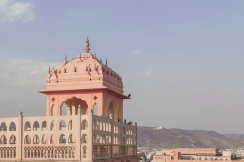 Majestic pink palace in Jaipur, India showcasing intricate architecture and rich history.