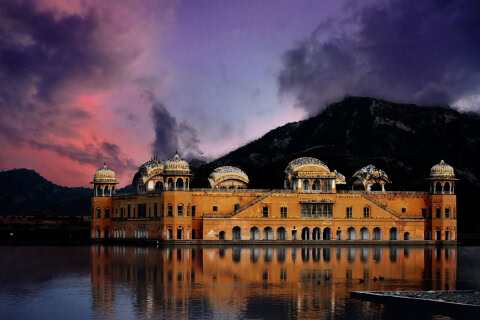 Majestic Amritsar Palace glowing in the sunset, reflecting the golden hues of the sky.